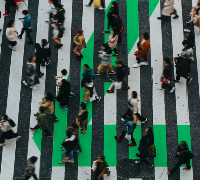 large crosswalk of people walking through