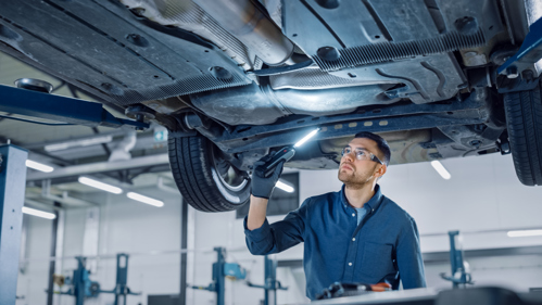 Employee inspecting an automobile