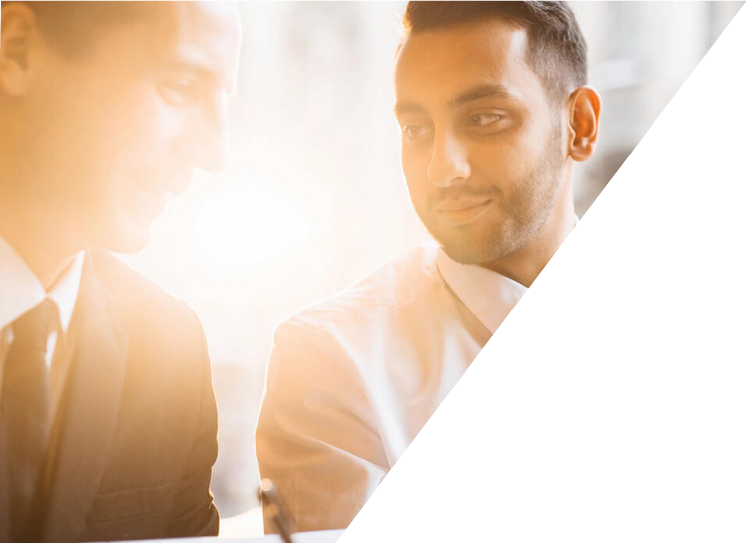 Two men in business attire in gentle conversation about business matters.