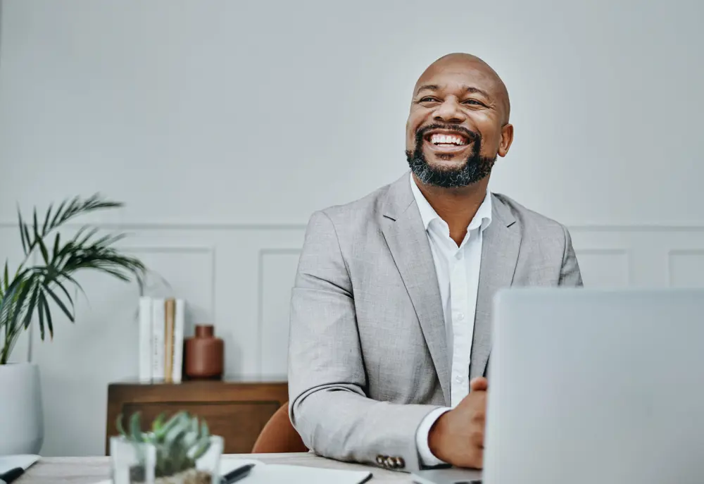 Shot of a mature businessman using a laptop in a modern office
